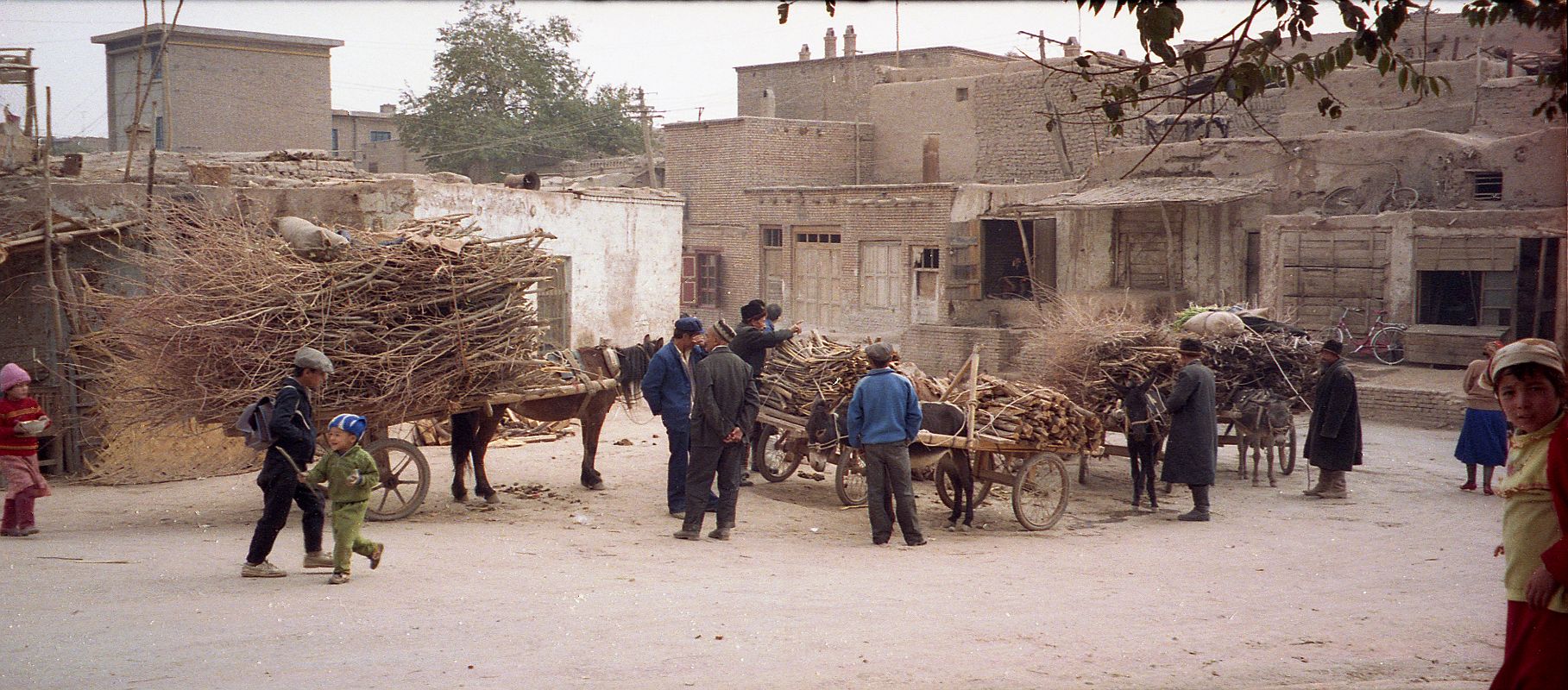 11 Kashgar Old City Street Scene 1993 Donkey Carts Being Loaded With Wood